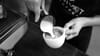 Close up of a barista pouring latte art