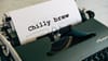A typewriter with "Chilly brew" written on the paper